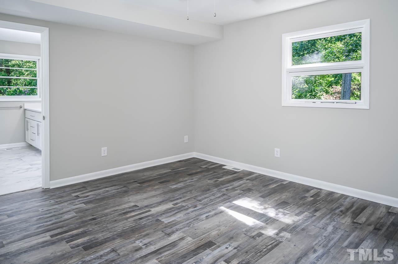 3401 Forest Road Raleigh, NC 27604 - Photo 14 of 30 a view of a room with wooden floor and windows