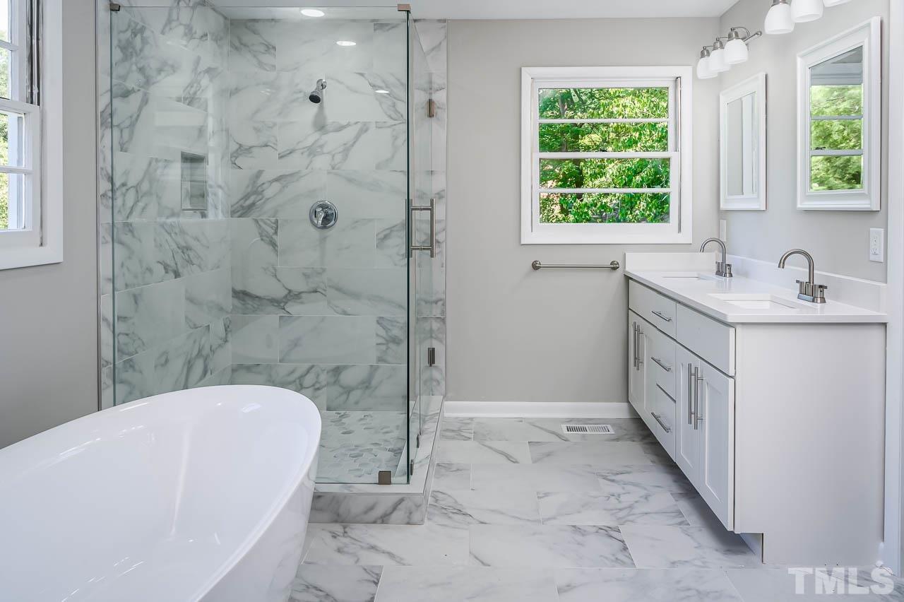 3401 Forest Road Raleigh, NC 27604 - Photo 15 of 30 a bathroom with a sink a toilet and shower