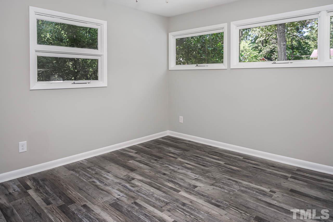3401 Forest Road Raleigh, NC 27604 - Photo 19 of 30 a view of an empty room with wooden floor and a window