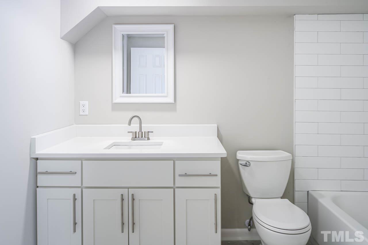 3401 Forest Road Raleigh, NC 27604 - Photo 21 of 30 a bathroom with a toilet a sink and mirror