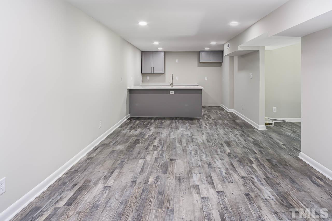 3401 Forest Road Raleigh, NC 27604 - Photo 22 of 30 a view of a kitchen with wooden floor and electronic appliances