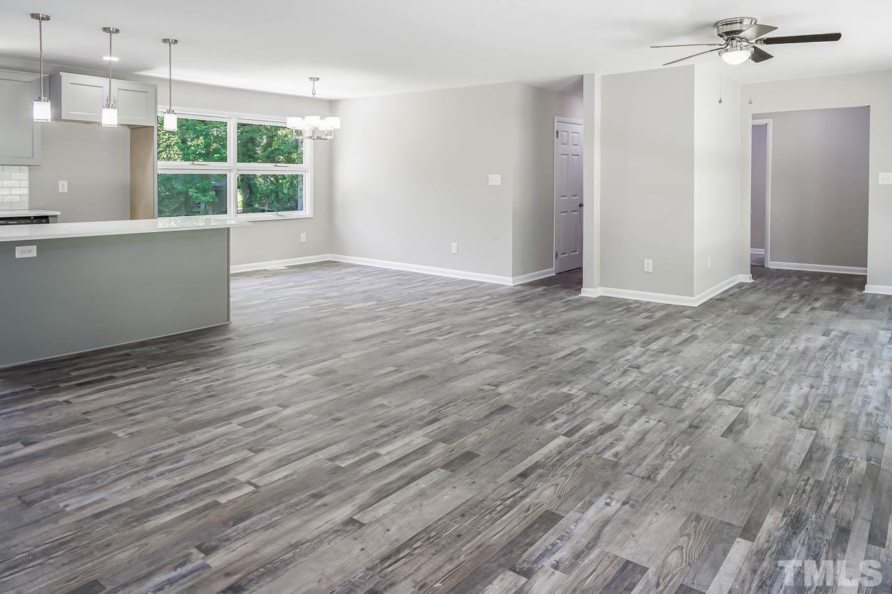 3401 Forest Road Raleigh, NC 27604 - Photo 7 of 30 an empty room with wooden floor and windows