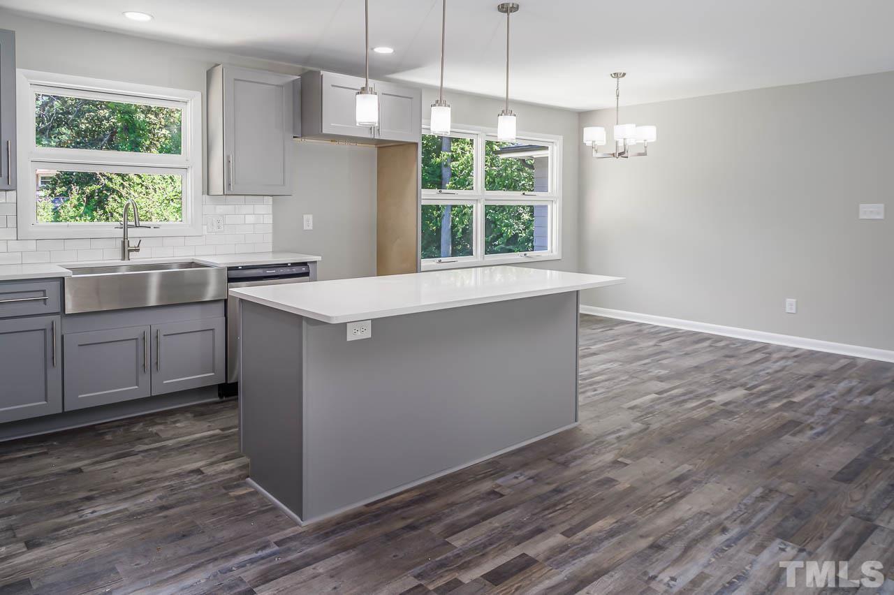 3401 Forest Road Raleigh, NC 27604 - Photo 10 of 30 a kitchen with granite countertop a stove a sink and a window