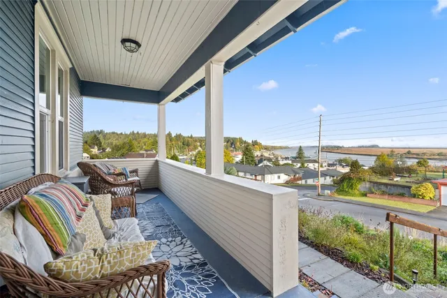 a balcony with furniture and a floor to ceiling window