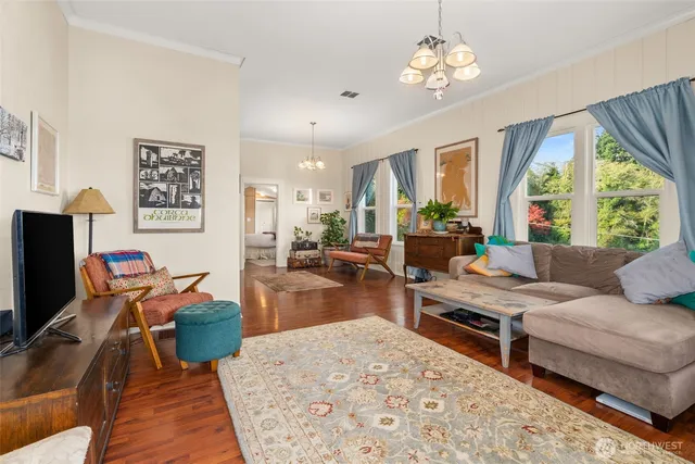 a living room with furniture a flat screen tv and a large window