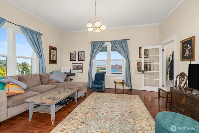 a living room with furniture a fireplace and a large window
