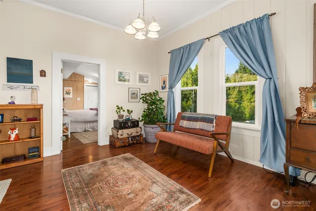 a living room with furniture a window and wooden floor