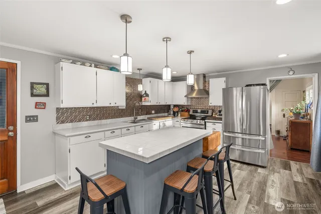 a kitchen with a table chairs refrigerator and cabinets