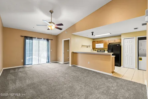 a view of a kitchen with a sink and a window