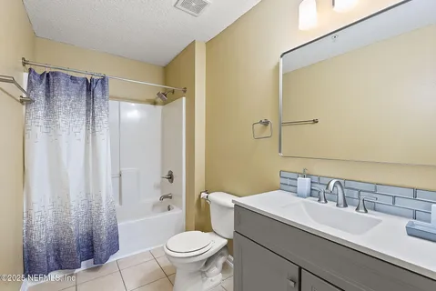 a bathroom with a sink toilet a mirror and shower
