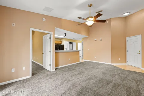 a view of a kitchen with a sink and a refrigerator