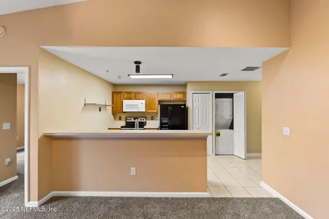 a view of a kitchen with kitchen island a counter top space and appliances