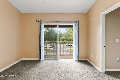 a view of an empty room with glass door