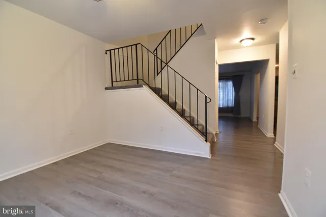 a view of a hallway with wooden floor and entryway