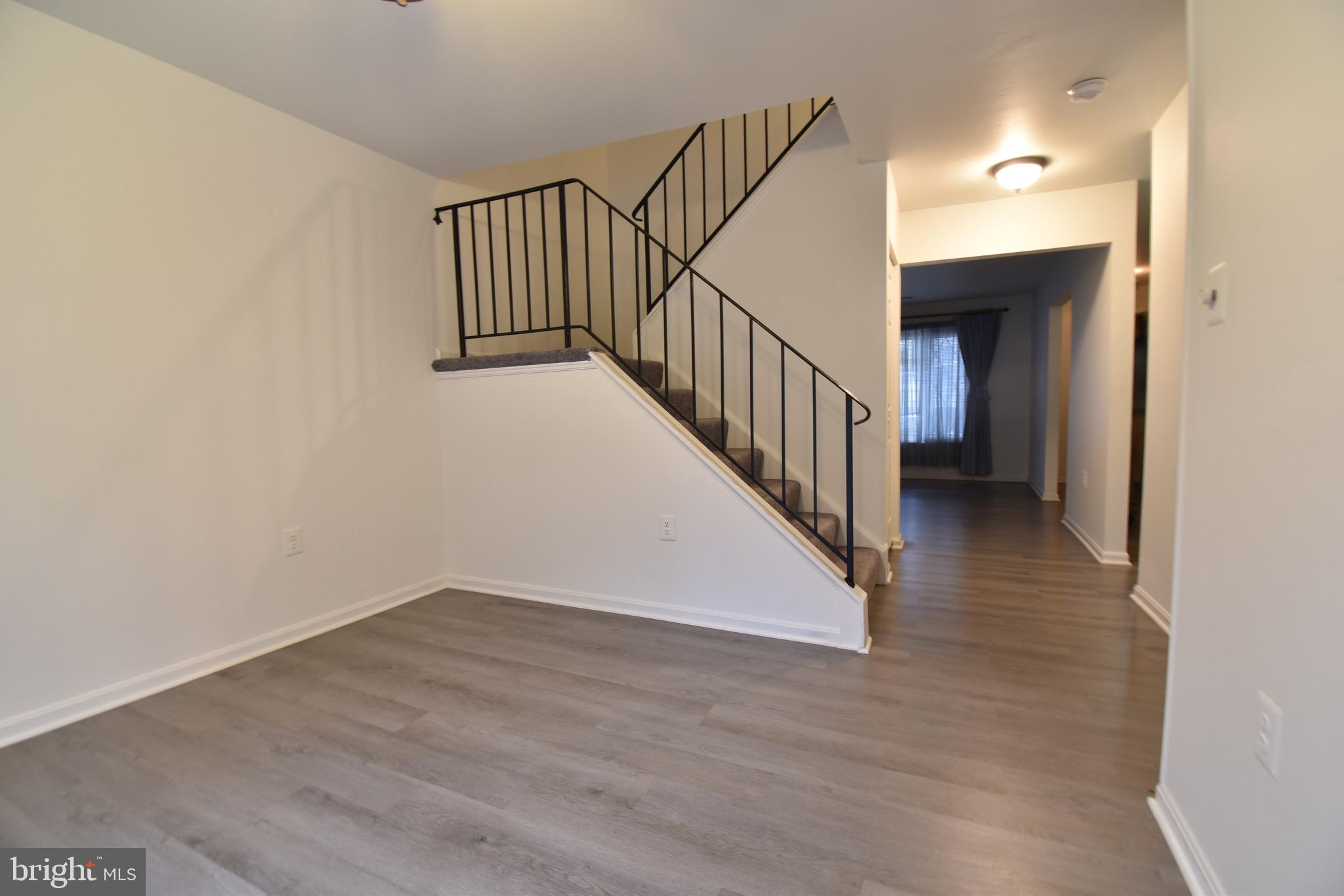 7730 Merrick Lane Landover, MD 20785 - Photo 12 of 19 a view of a hallway with wooden floor and entryway