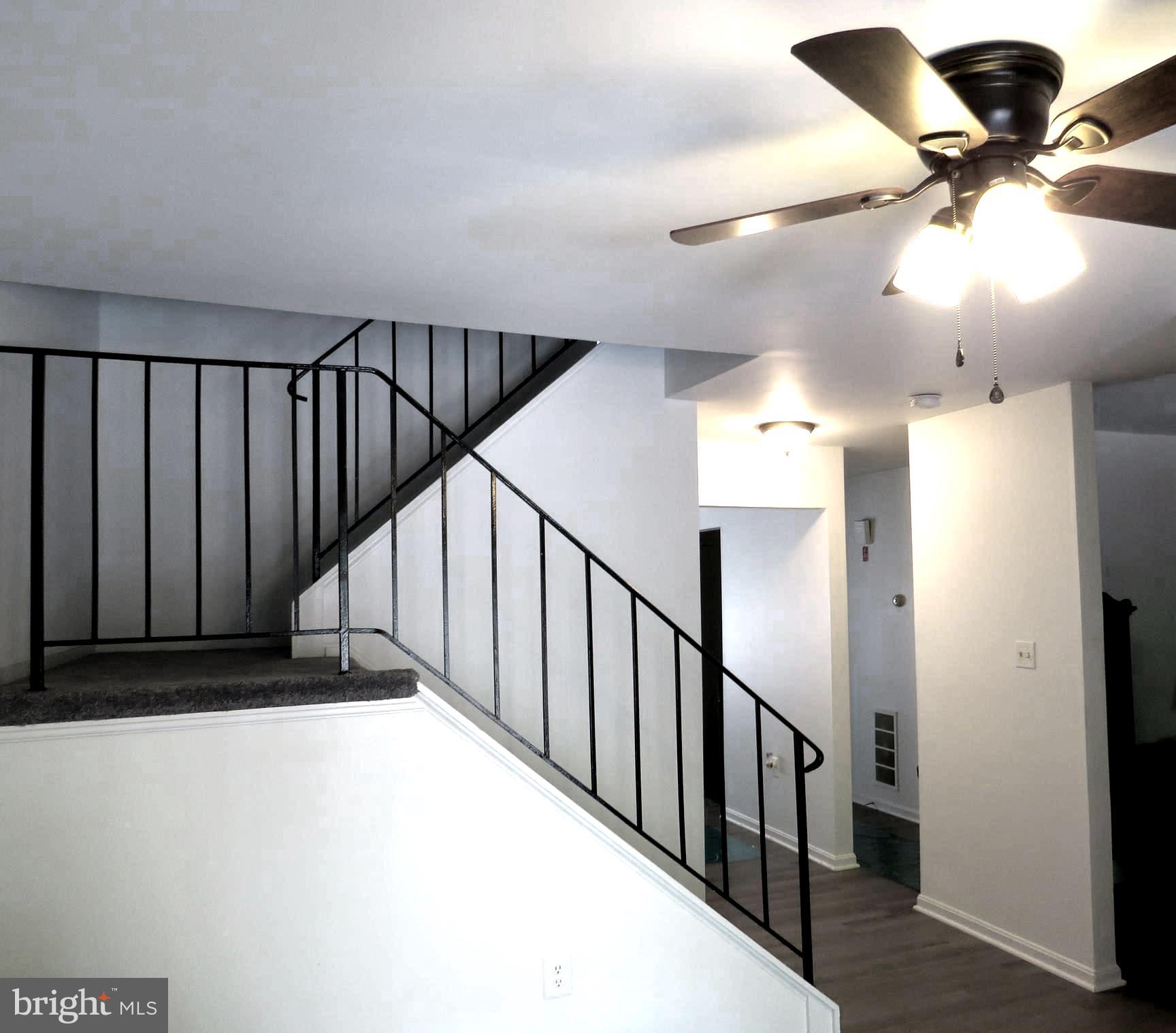 7730 Merrick Lane Landover, MD 20785 - Photo 17 of 19 a view of staircase with railing and white walls