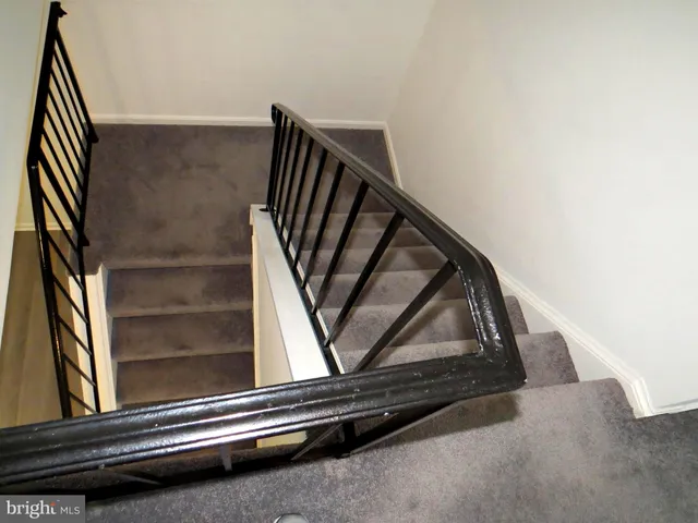 a view of staircase with wooden floor