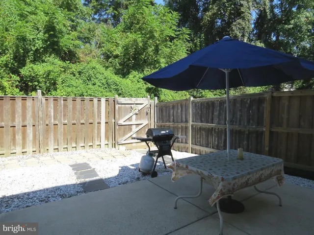 a backyard of a house with table and chairs