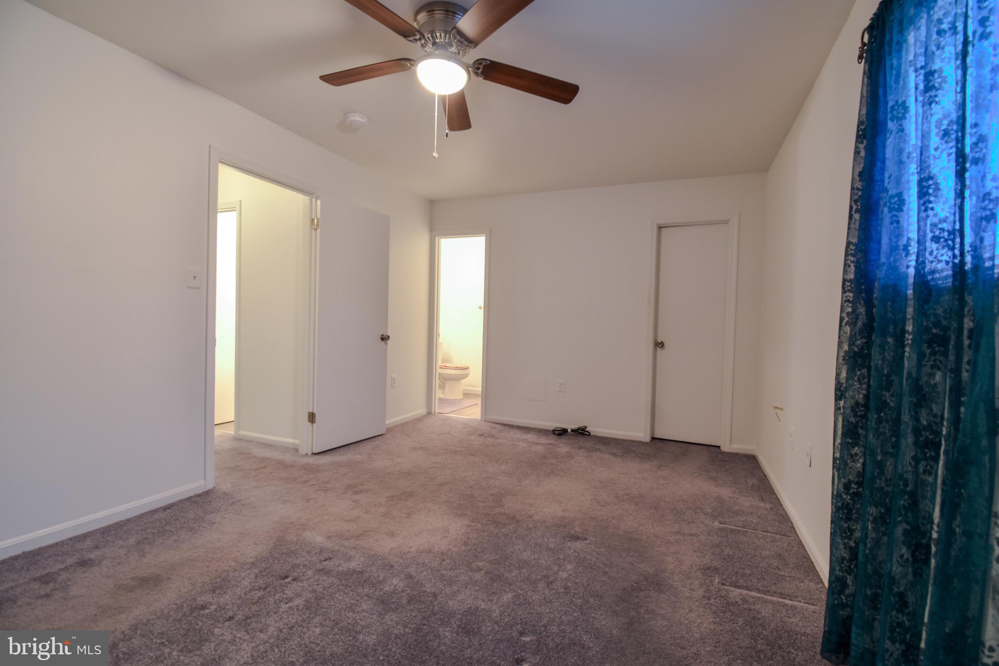 7730 Merrick Lane Landover, MD 20785 - Photo 6 of 19 an empty room with chandelier fan and windows