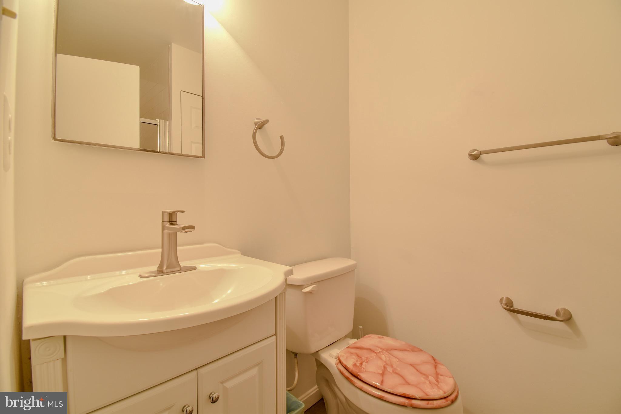 7730 Merrick Lane Landover, MD 20785 - Photo 10 of 19 a bathroom with a sink a toilet and a mirror
