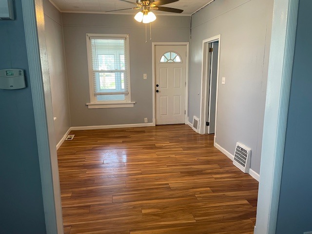 214 North 3rd Street Clinton, IA 52732 - Photo 3 of 11 a view of an empty room with window and chandelier fan