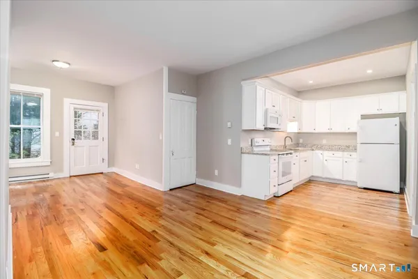 a view of kitchen with wooden floor