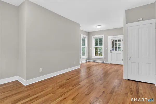 wooden floor in an empty room with a window