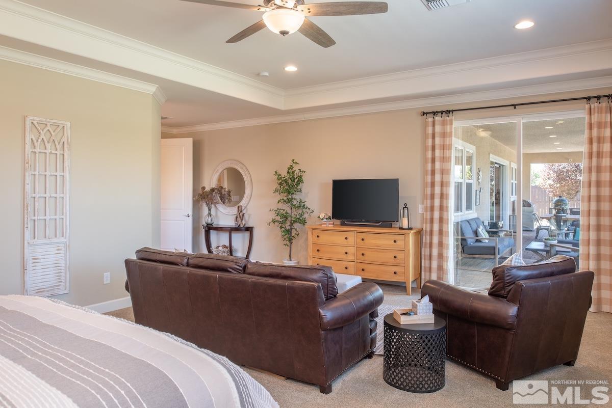 9865 Sea Breeze Lane Reno, NV 89521 - Photo 15 of 36 a living room with furniture ceiling fan and a flat screen tv