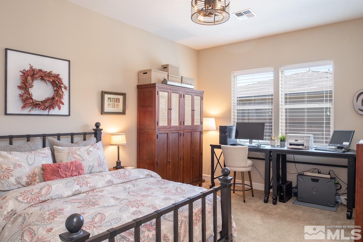 9865 Sea Breeze Lane Reno, NV 89521 - Photo 23 of 36 a bedroom that has a bed and a table in it