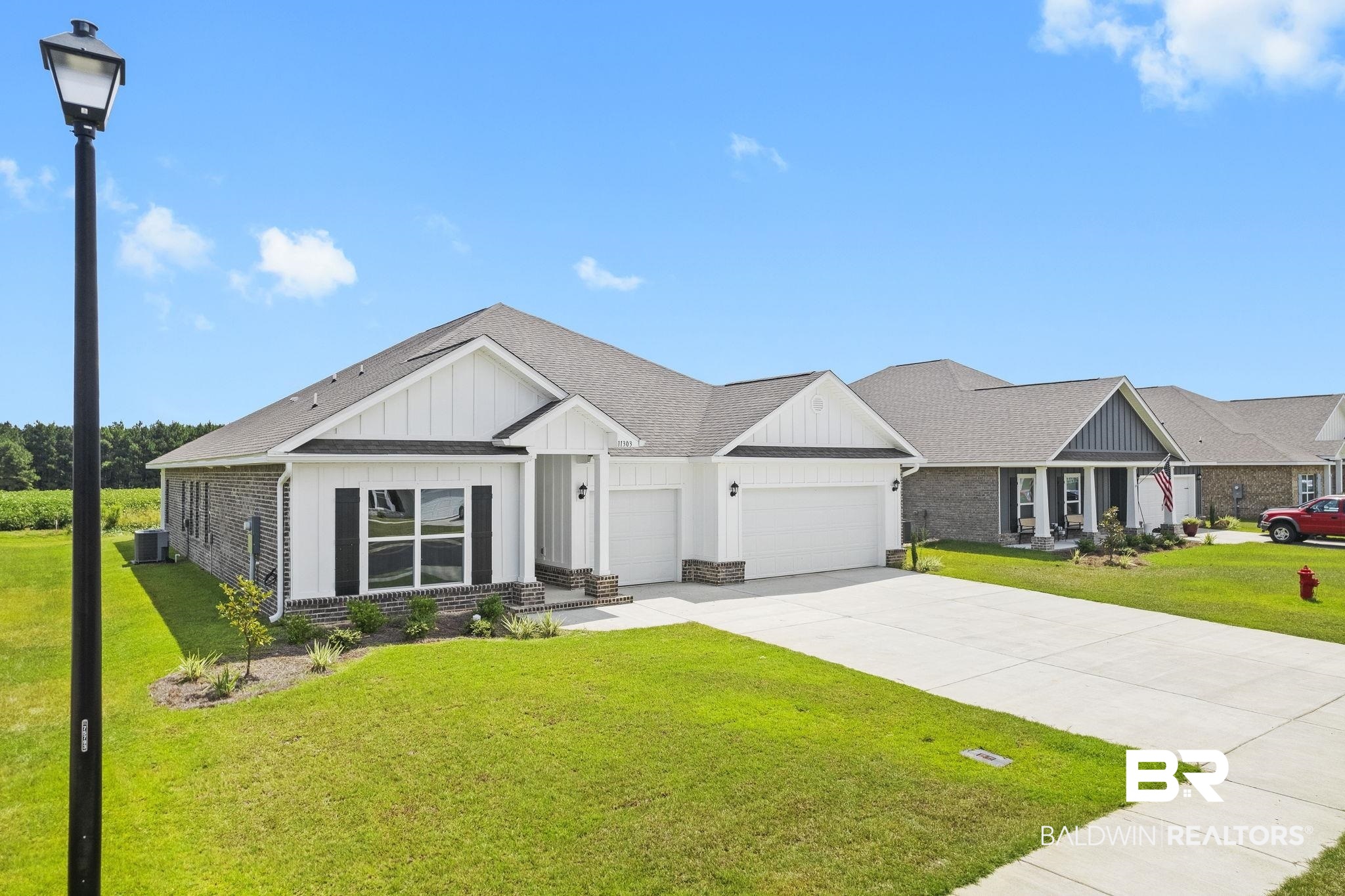 11303 Genuine Risk Circle Daphne, AL 36526 - Photo 83 of 100 View of front of house featuring a garage, a front lawn, and cooling unit