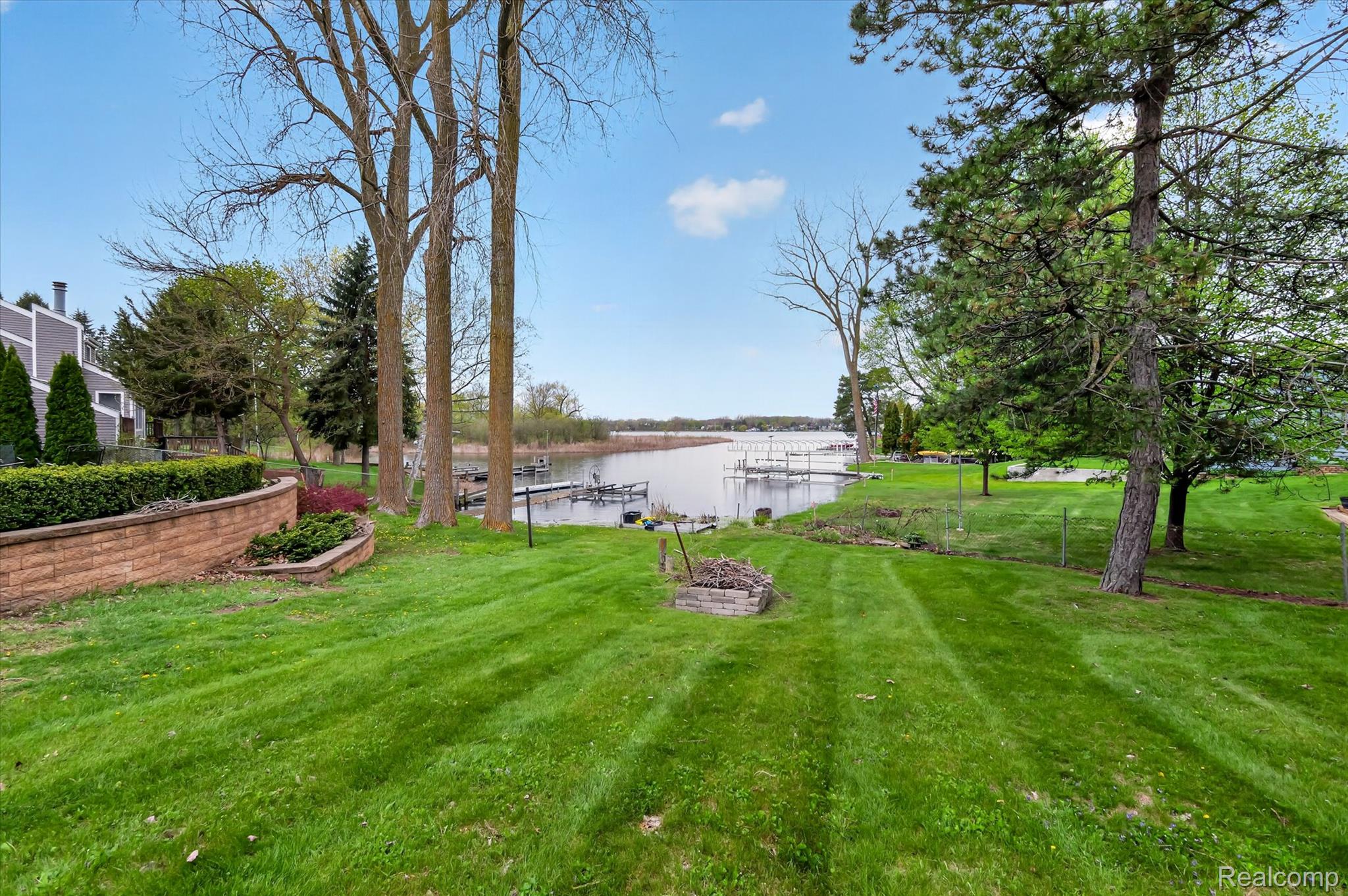 2264 Crane Road Fenton, MI 48430 - Photo 7 of 55 View of grassy yard featuring a water view and a dock