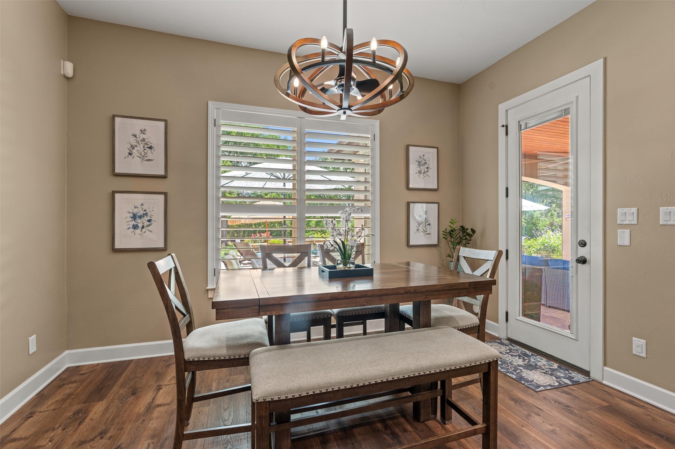 104 Adobe Cove Georgetown, TX 78633 - Photo 11 of 40 Hardwood floors and a statement light fixture adorn this elegant dining area, perfect for entertaining.