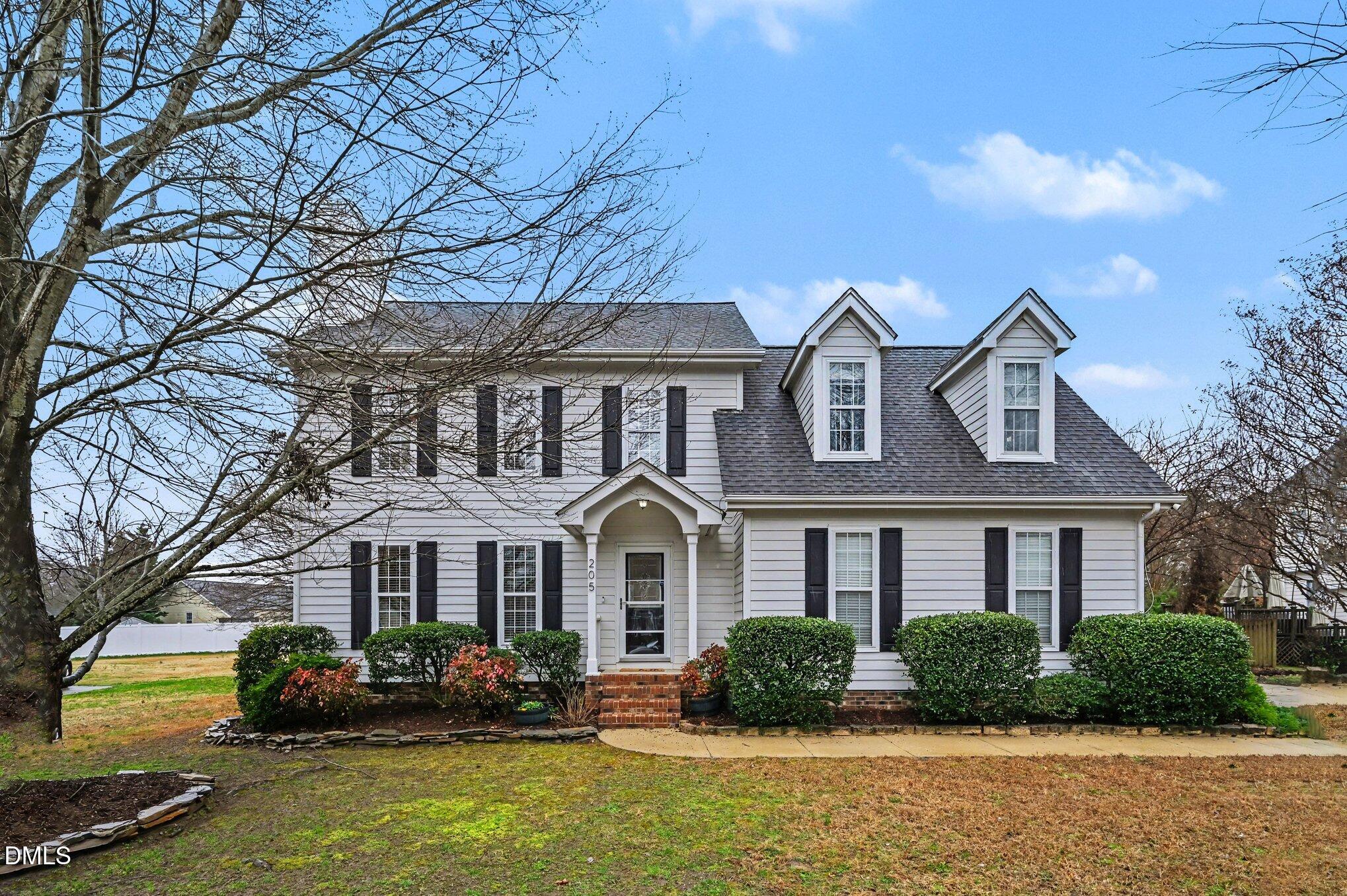 205 Weathervane Way Holly Springs, NC 27540 - Photo 1 of 25 a front view of a house with garden