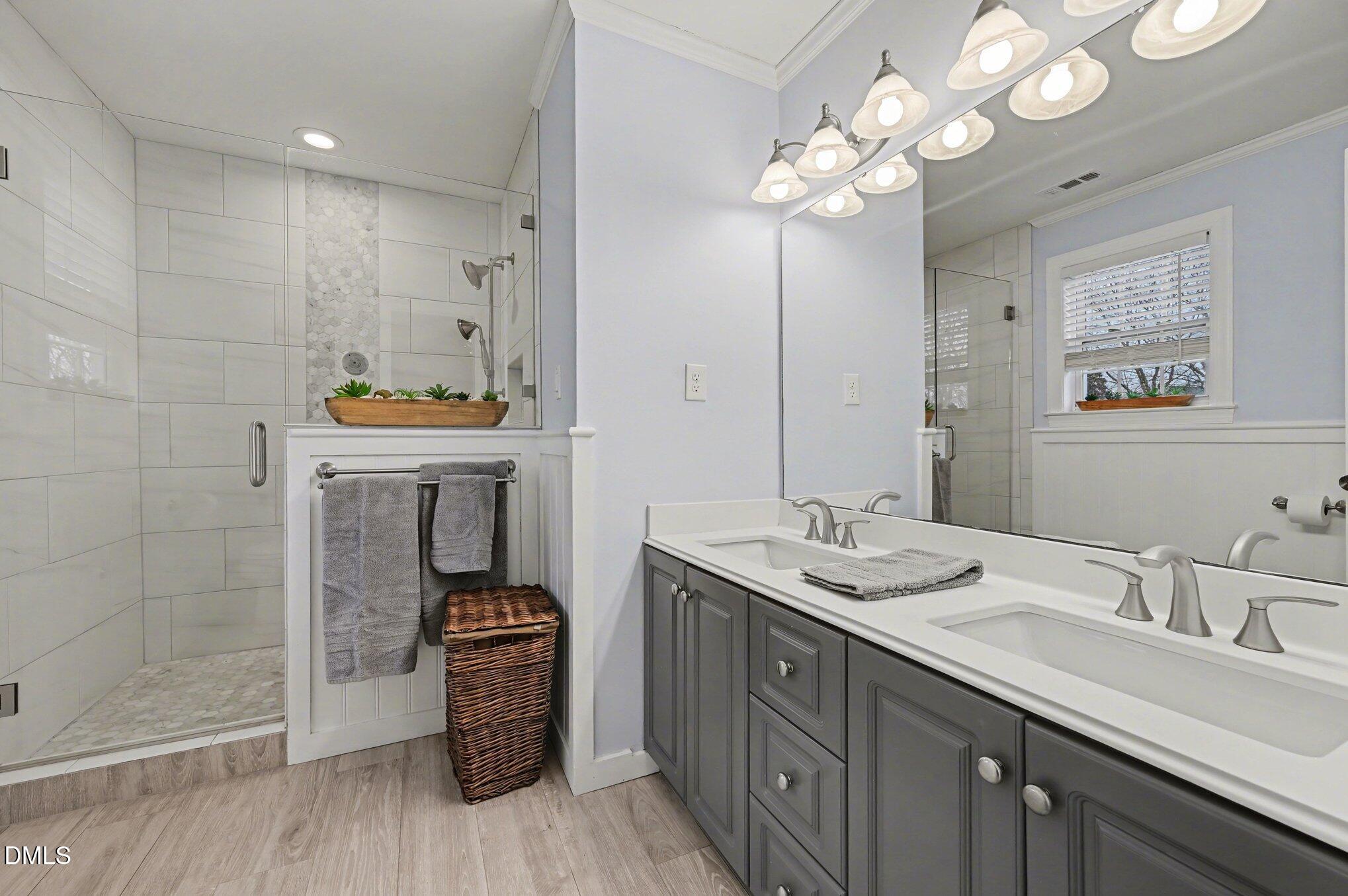 205 Weathervane Way Holly Springs, NC 27540 - Photo 10 of 25 a spacious bathroom with a granite countertop sink a large mirror and shower