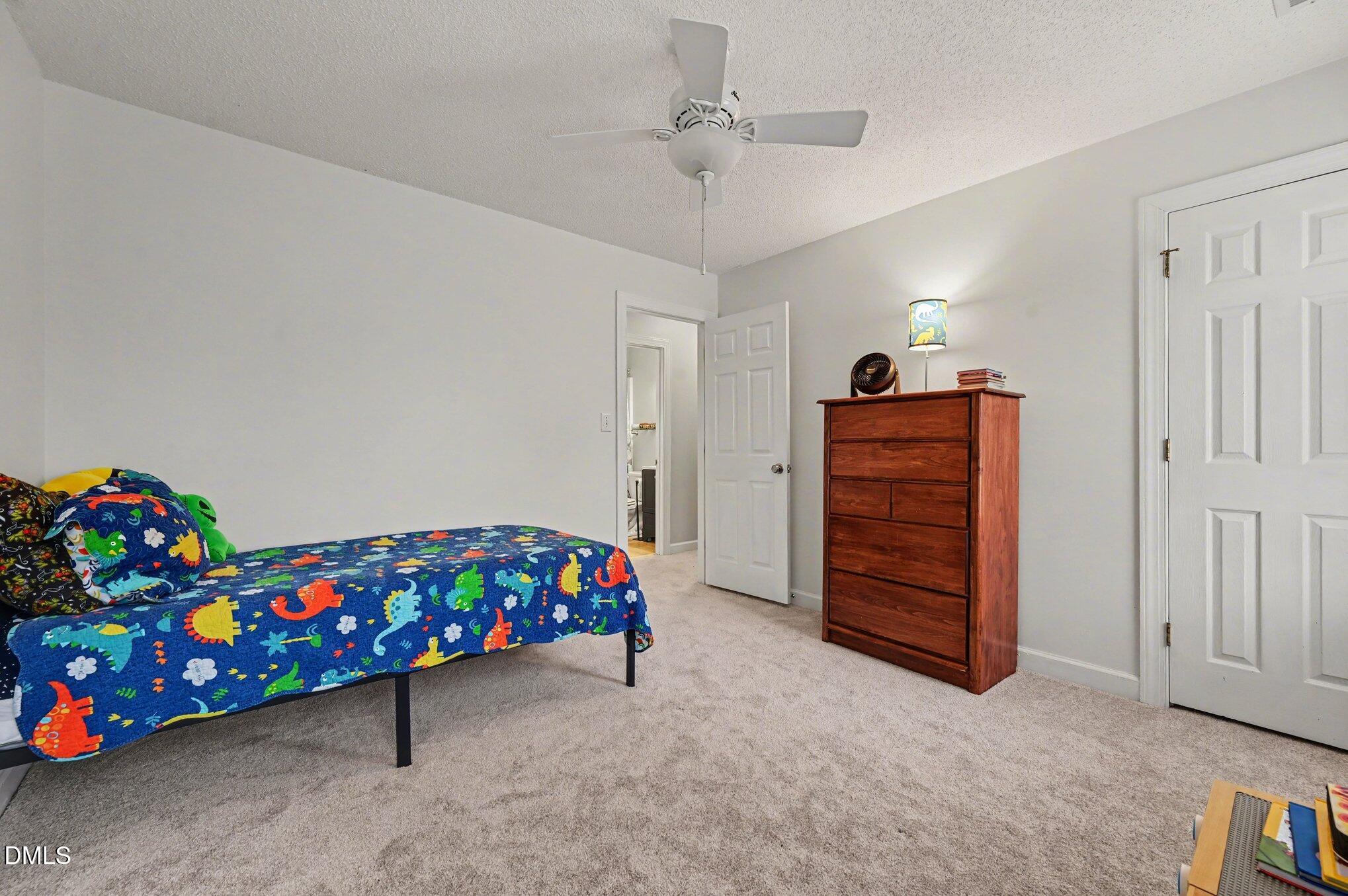 205 Weathervane Way Holly Springs, NC 27540 - Photo 11 of 25 a bedroom with a bed and a dresser