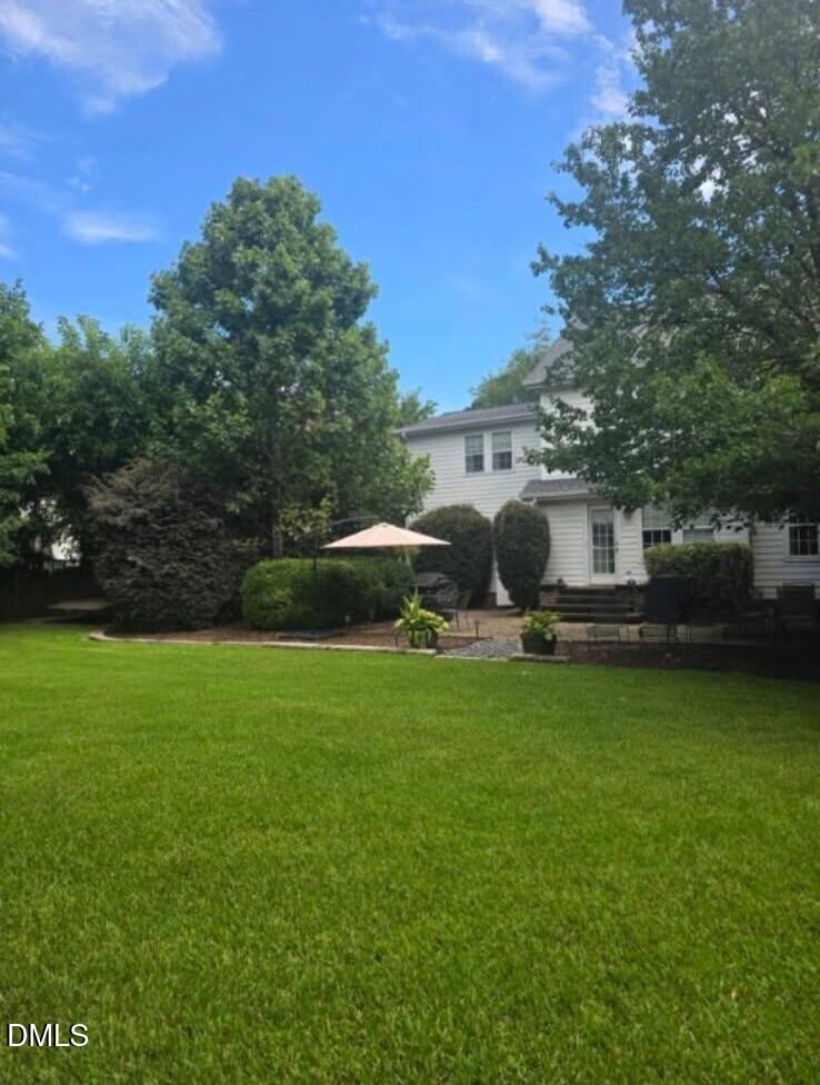 205 Weathervane Way Holly Springs, NC 27540 - Photo 21 of 25 a front view of a house with garden and trees
