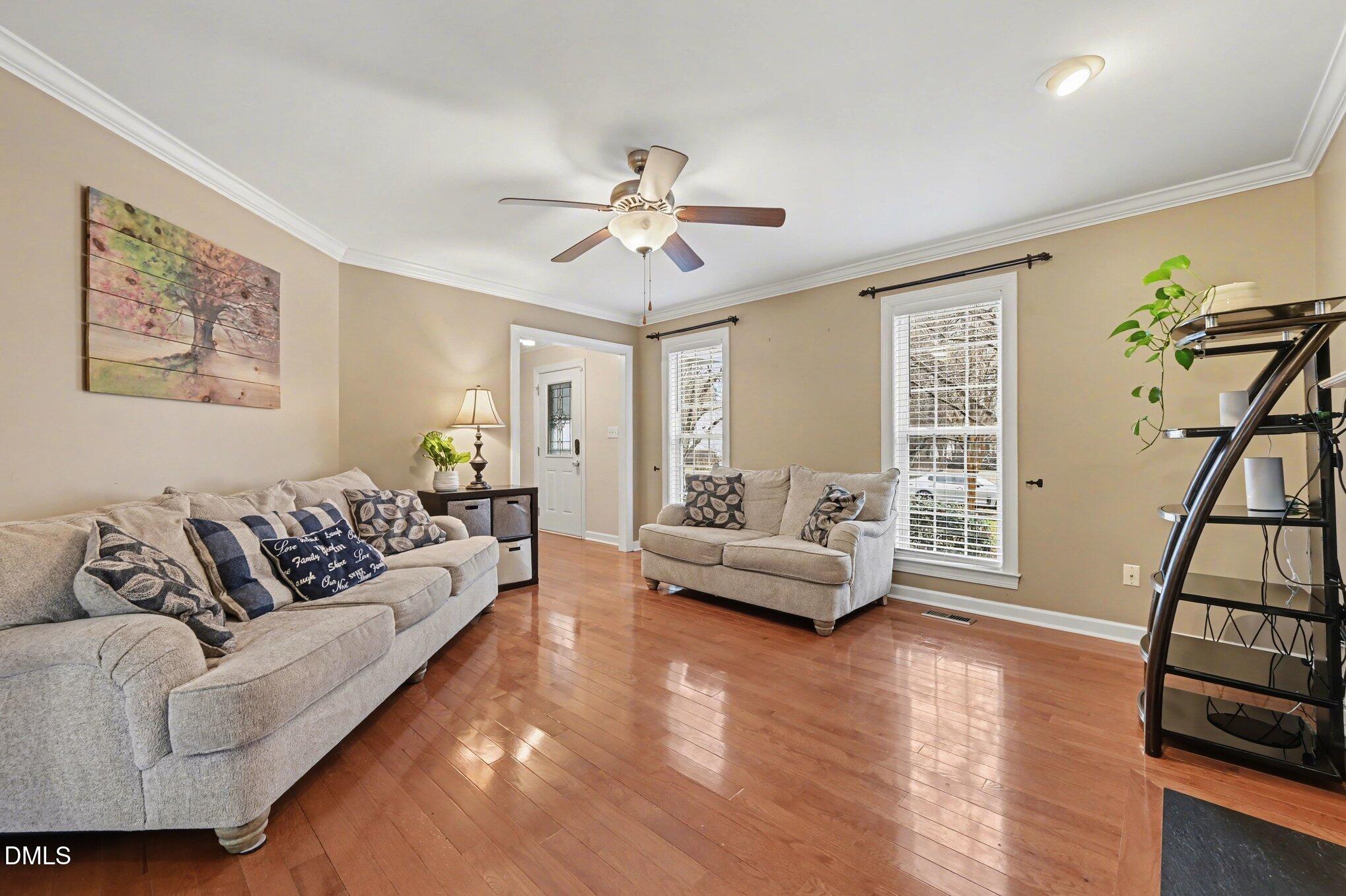 205 Weathervane Way Holly Springs, NC 27540 - Photo 3 of 25 a living room with furniture and a wooden floor