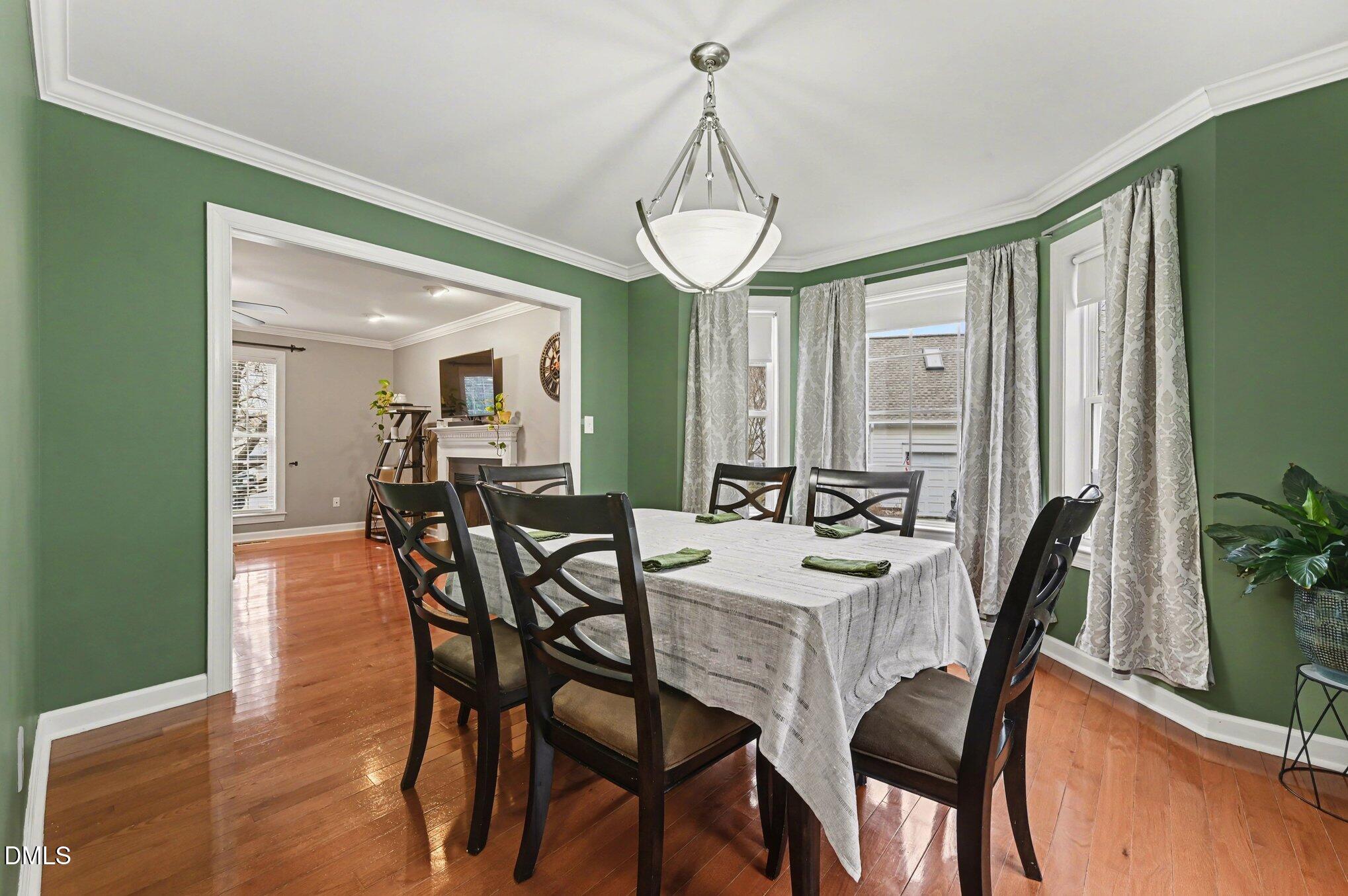 205 Weathervane Way Holly Springs, NC 27540 - Photo 4 of 25 a view of a dining room with furniture window and wooden floor