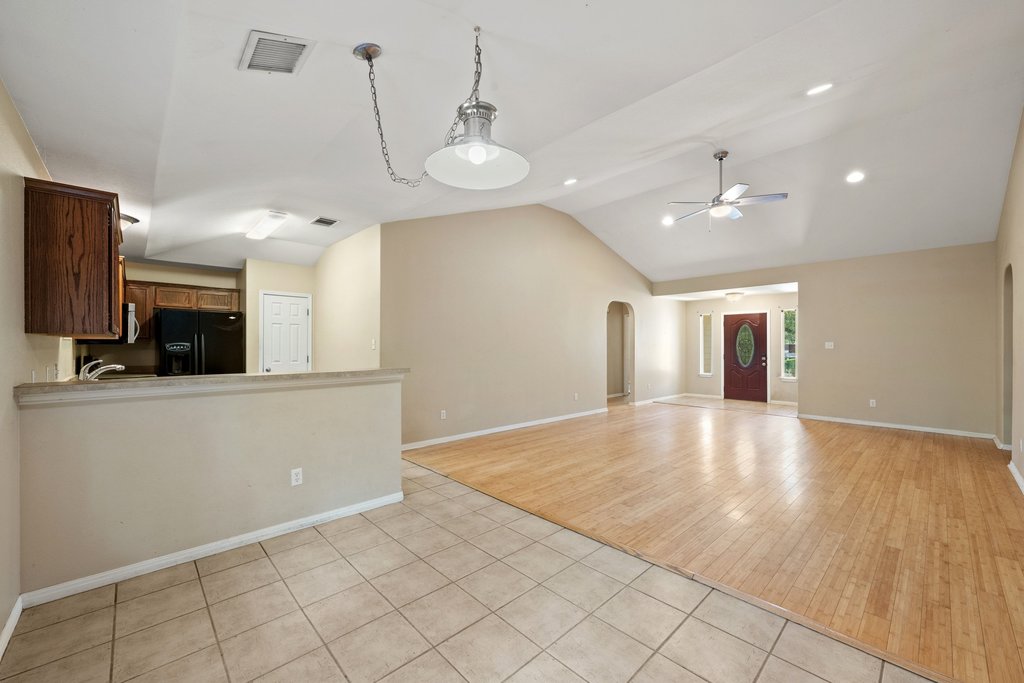 5208 Sioux Lane Austin, TX 78734 - Photo 12 of 35 A spacious, open-concept interior featuring a blend of hardwood and tile flooring, perfect for versatile living.