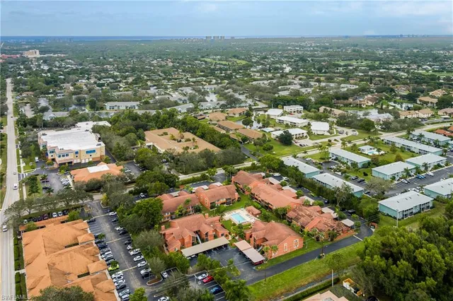 an aerial view of residential houses with city view