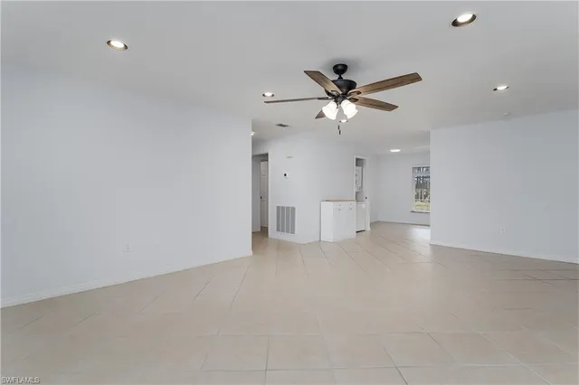a view of a livingroom with a ceiling fan and window