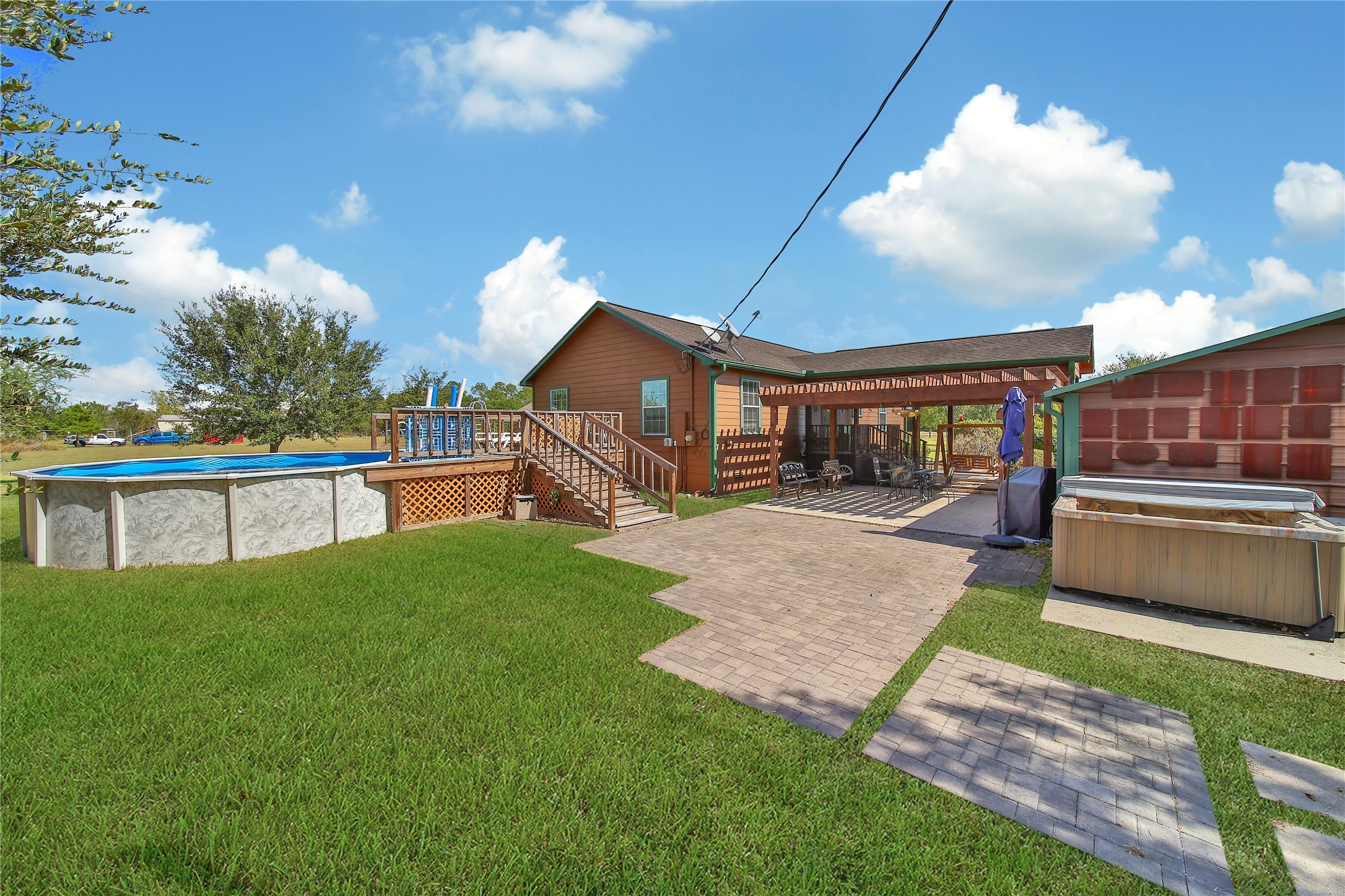 6151 West Creek Road East Bernard, TX 77435 - Photo 16 of 48 a view of a house with a yard and a patio