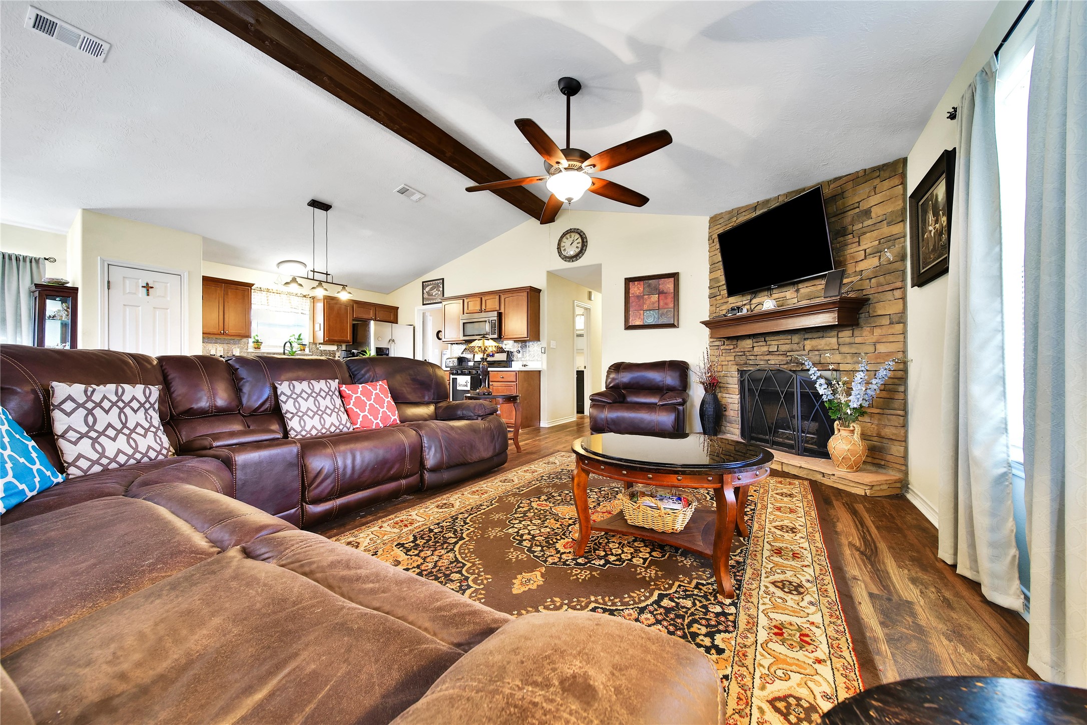 6151 West Creek Road East Bernard, TX 77435 - Photo 24 of 48 a living room with furniture a flat screen tv and a fireplace