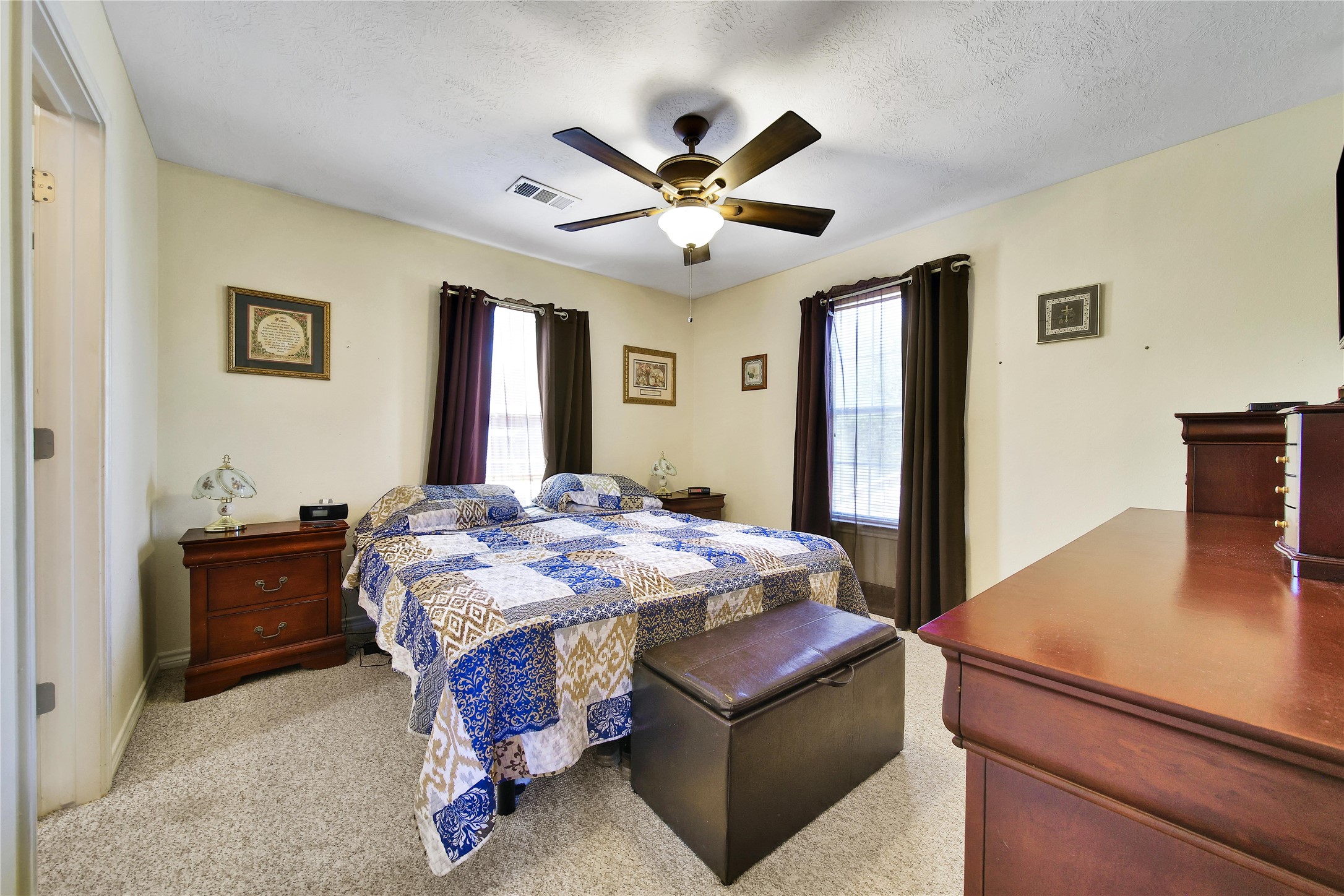 6151 West Creek Road East Bernard, TX 77435 - Photo 31 of 48 a bedroom with a bed and a chandelier