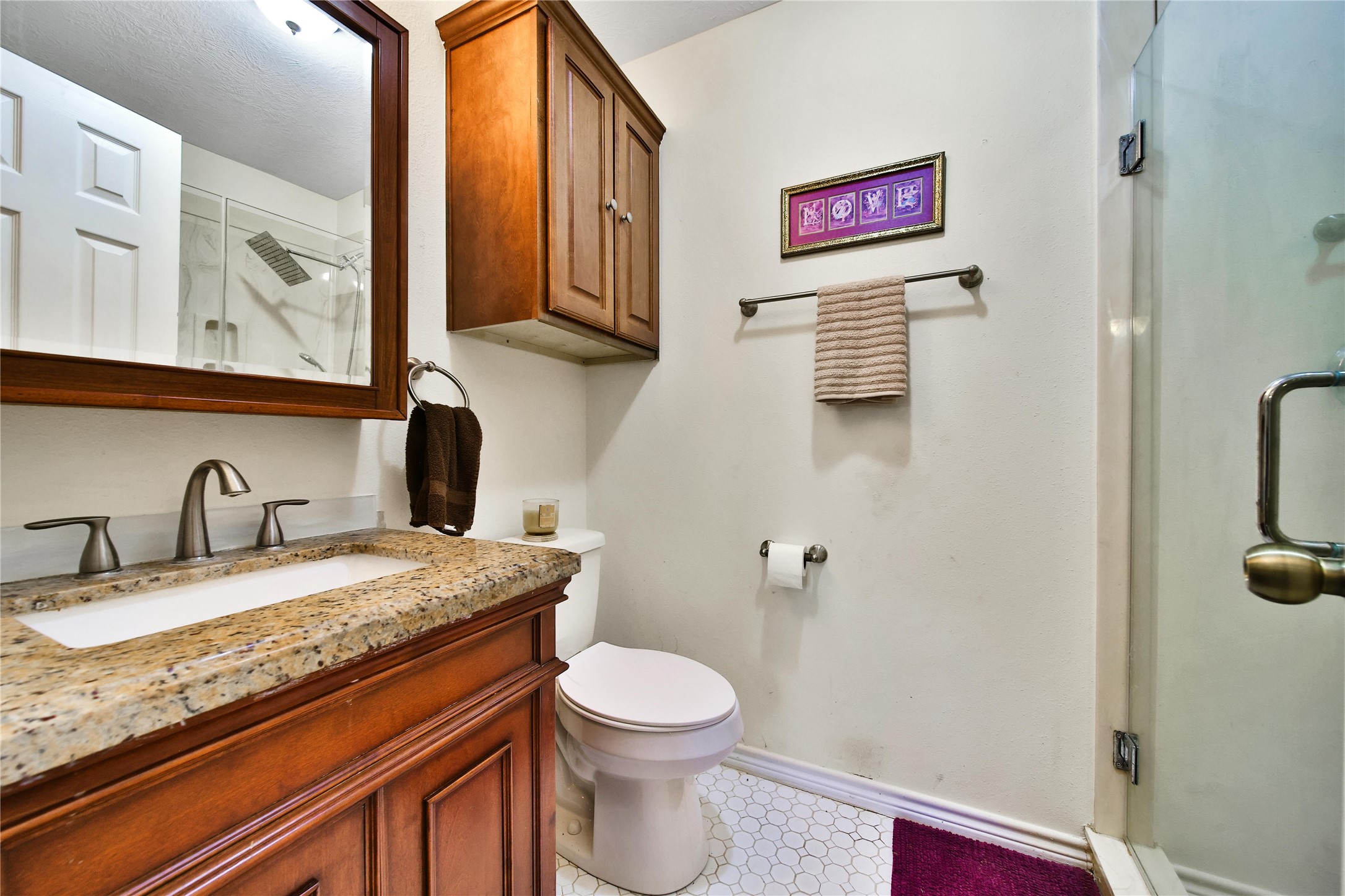 6151 West Creek Road East Bernard, TX 77435 - Photo 33 of 48 a bathroom with a granite countertop toilet sink and mirror