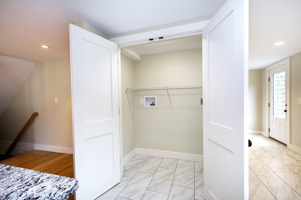 128 Washington Street, Unit R Hanover, MA 02339 - Photo 12 of 29 a view of a hallway with wooden floor and cabinet