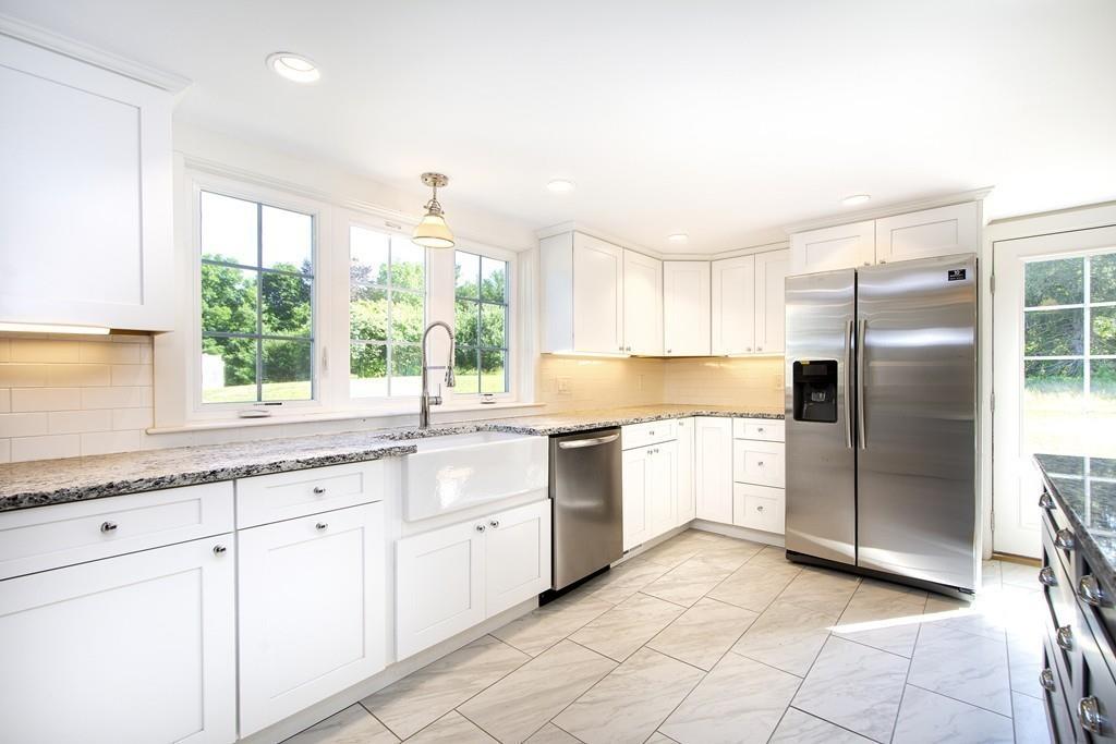 128 Washington Street, Unit R Hanover, MA 02339 - Photo 13 of 29 a kitchen with granite countertop white cabinets and white stainless steel appliances