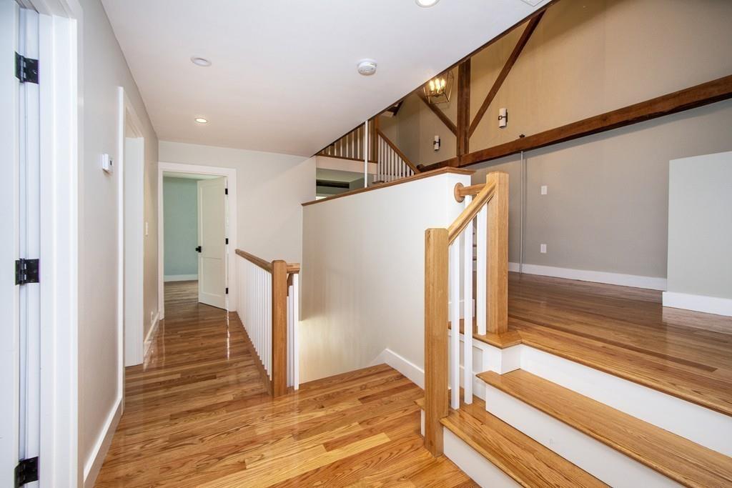 128 Washington Street, Unit R Hanover, MA 02339 - Photo 16 of 29 a view of a hallway with wooden floor and staircase