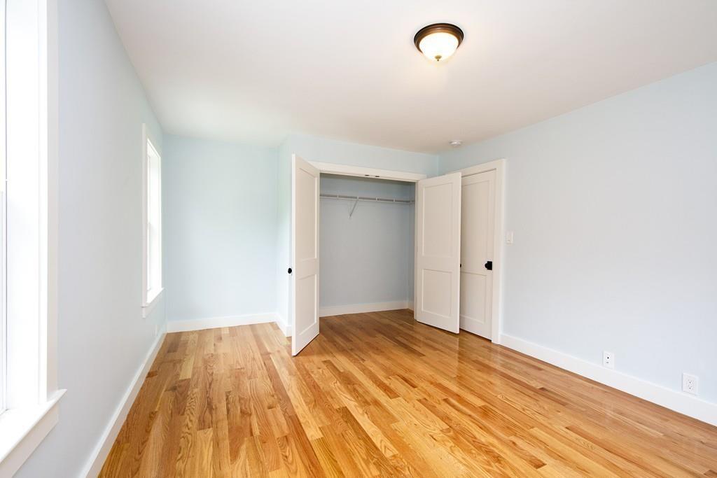 128 Washington Street, Unit R Hanover, MA 02339 - Photo 18 of 29 a view of a room with wooden floor and white walls