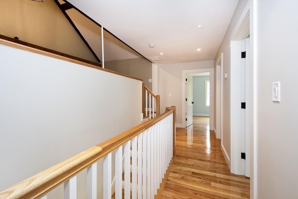 128 Washington Street, Unit R Hanover, MA 02339 - Photo 19 of 29 a view of a hallway with wooden floor and staircase